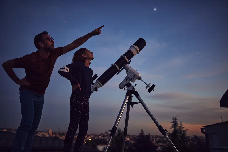 Stargazing through telescope. An important personal finance tip is to set and use your financial North Star to guide you in increasing your wealth.